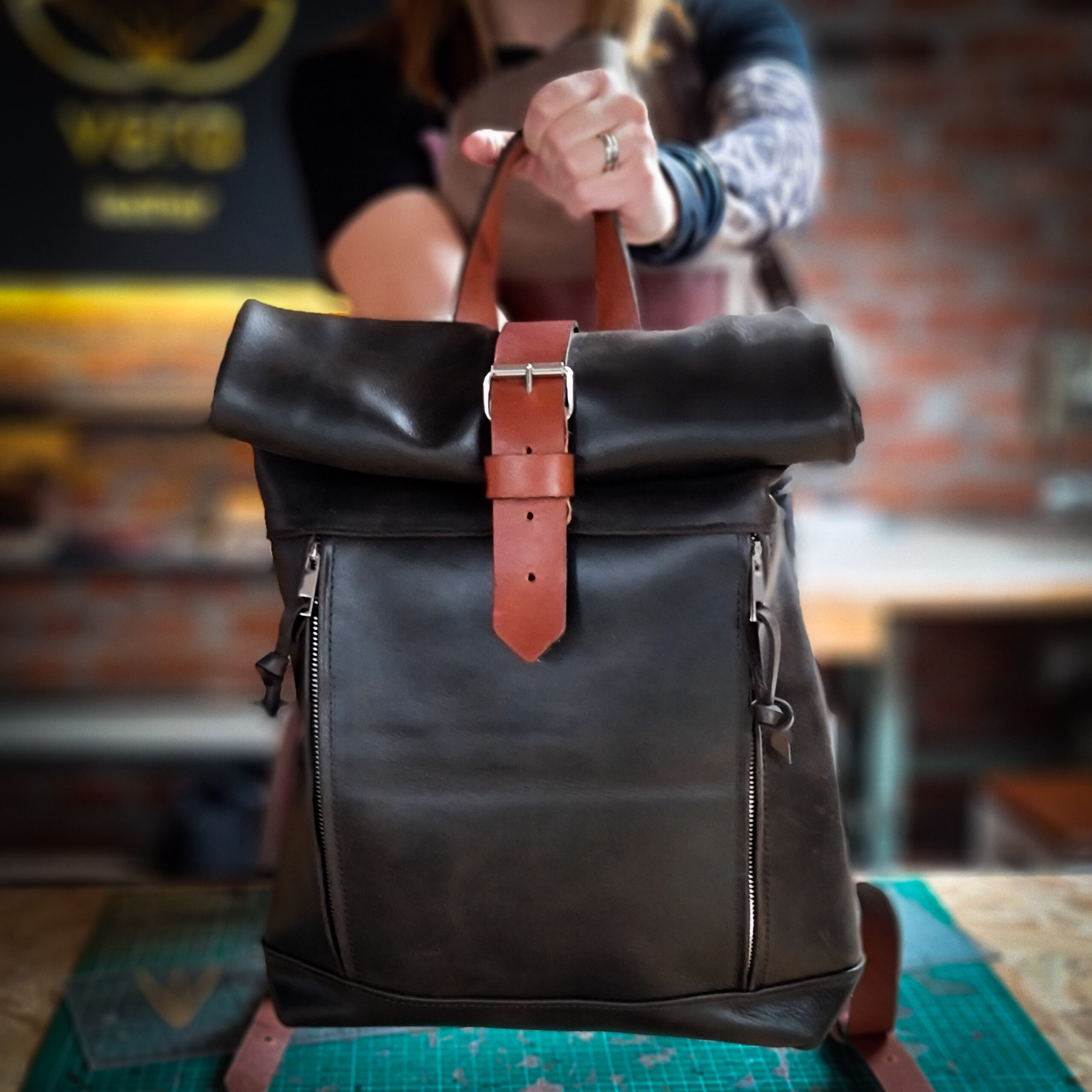Roll top leather backpack